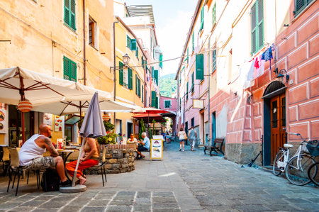 Monterosso Al Mare, Italy - September 02, 2019: People are walking, traveling by a cozy vibrant streets full of small businesses on the ground floor in Monterosso Al Mare, Cinque Terre, Italyのeditorial素材