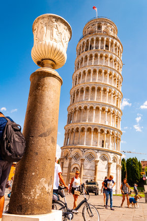 Pisa, Italy - September 03, 2019: Low angle perspective view on the famous leaning Tower of Pisa or La Torre di Pisa at the Cathedral Square, Piazza del Duomo together with cathedral column in Pisaのeditorial素材