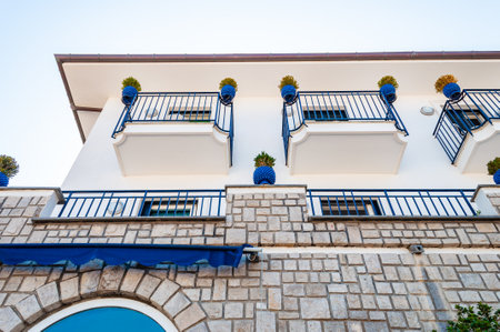 Vico Equense, Naples, Italy - September 05, 2019: Traditional white and blue facades of the buildings decorated with plants in vibrant pots on the balconies in Vico Equensea a coastal town in Italyのeditorial素材