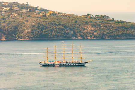Medieval sailing with five masts floating in near the Tyrrhenian sea bay near the rocky surroundings of Meta, Sant'Agnello and Sorrento cities near Naples region in Italyの写真素材