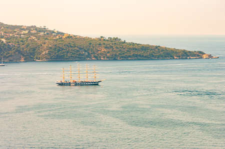 Medieval sailing with five masts floating in near the Tyrrhenian sea bay near the rocky surroundings of Meta, Sant'Agnello and Sorrento cities near Naples region in Italyの写真素材