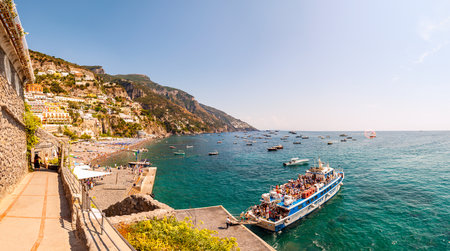 Positano, Italy - September 05, 2019: Amazing Positano cityscape on rocky landscape, people on the beach, boats are coming and going to the sea tours, promenades full of apartments and businessesのeditorial素材