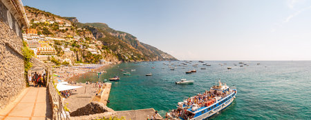 Positano, Italy - September 05, 2019: Amazing Positano cityscape on rocky landscape, people on the beach, boats are coming and going to the sea tours, promenades full of apartments and businessesのeditorial素材