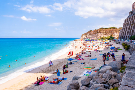 Rotonda Beach, Tropea, Calabria, Italy - September 07, 2019: Landscape view on famous Rotonda Beach full of resting sunbathing and swimming people. Popular sea promenade in Tropea city in Italyのeditorial素材