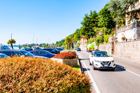 Toscolano Maderno, Lombardy, Italy - September 12, 2019: Scenic panoramic beltway road around lake Garda with medieval architecture buildings and rich northern Italy trees and plants growing on coastのeditorial素材