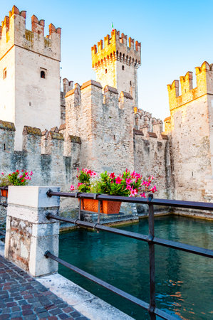 Sirmione, Lombardy, Italy - September 12, 2019: Fortress walls of the Scaligero Castle or Castle of Sirmione surrounded by water canals of the Garda lake.のeditorial素材