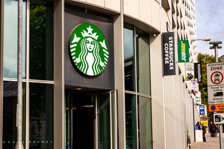 London, United Kingdom - September 14, 2017: Starbucks coffee bar outdoor logo hanging above the entrance in downtown.のeditorial素材