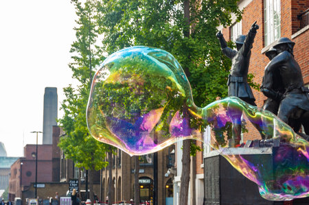 London, United Kingdom - September 18, 2017: Street artist performing blowing huge soap bubblesのeditorial素材