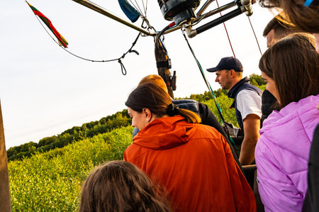 Vilnius, Lithuania - September 14, 2021: Passengers in the basket watching the landing process of hot air balloonのeditorial素材