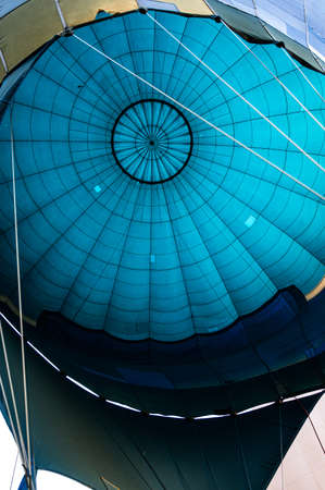 Inside view of blue bulb textile of balloon filled with hot air gas ready for take of to the skyの写真素材