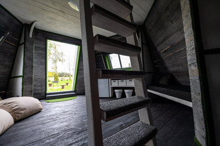 Wooden interior design. Living room of summer house. Pyramid shape bungalow from inside. Floor,...