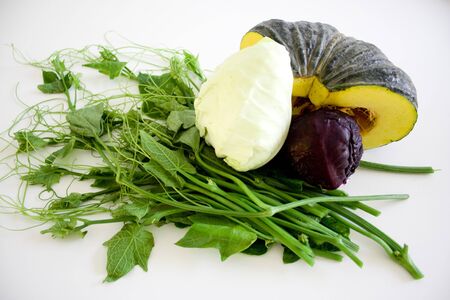 four different fresh vegetables on white backgroundの写真素材