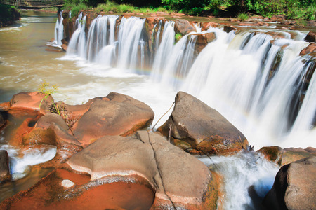 Waterfall in Laos with red waterの写真素材