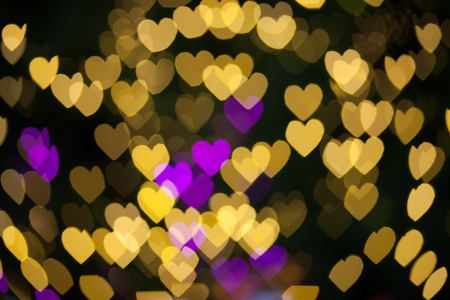 Abstract Yellow Purple lights Heart bokeh backgroundの写真素材
