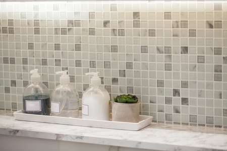 Liquid soap bottle with tile background Bathroom accessories.の写真素材