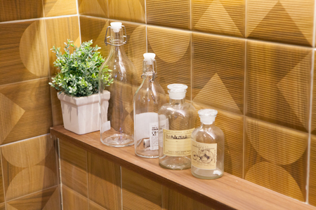 Empty glass bottles on wall backgroundの写真素材