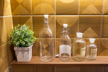 Empty glass bottles on wall backgroundの写真素材