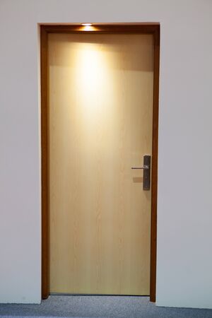 Close up of closed wooden door in low lightの写真素材