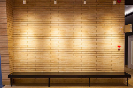 Bench with wall texture in low lightの写真素材