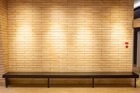 Bench with wall texture in low lightの写真素材