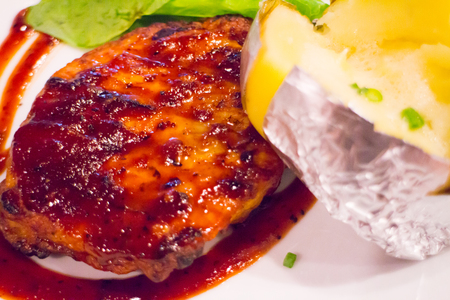 Grilled chicken steak on plate with baked potato and vegetable,Traditional cuisine. Grill kitchen.の写真素材