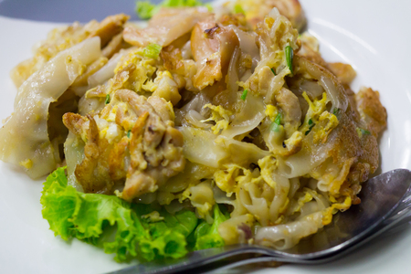 Stir fried flat noodle and chicken and egg Thai street foodの写真素材