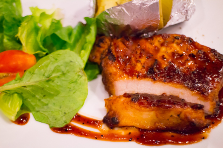 Grilled chicken steak on plate with baked potato and vegetable,Traditional cuisine. Grill kitchen.の写真素材
