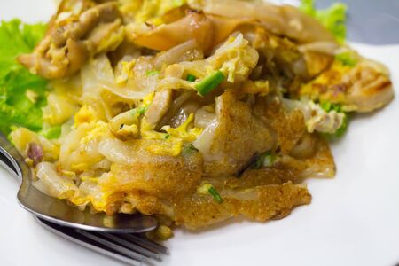 Stir fried flat noodle and chicken and egg Thai street foodの写真素材
