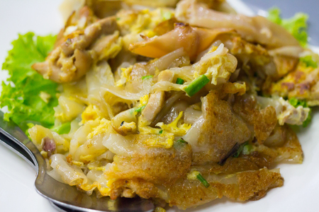Stir fried flat noodle and chicken and egg Thai street foodの写真素材