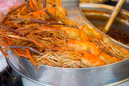 group of delicious streaming jumbo shrimps prawn in Thai street food market.の写真素材