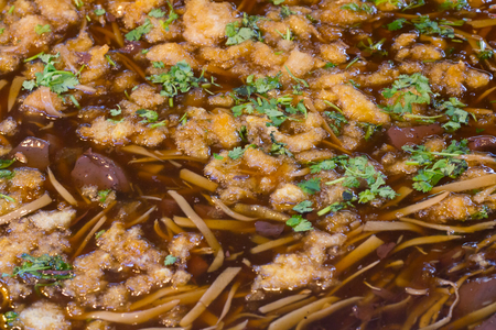 braised fish maw with red gravy sauce in big pan on marketの写真素材