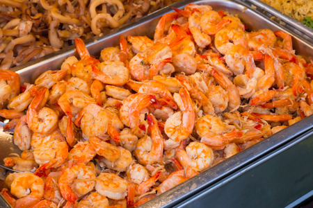 Group of delicious streaming jumbo shrimps prawn in Thai street food market.の写真素材