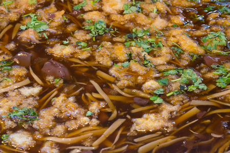 Braised fish maw with red gravy sauce in big pan on marketの写真素材