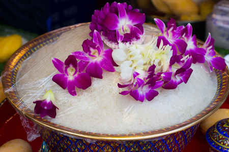 Cooked rice in bowl  and orchid . Thai ancient styleの写真素材