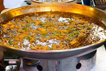 braised fish maw with red gravy sauce in big pan on marketの写真素材