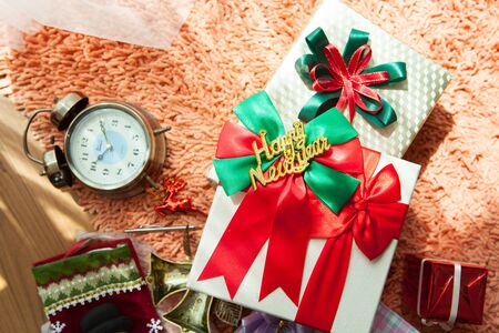 White gift box and red ribbon  on wood background with space.の写真素材