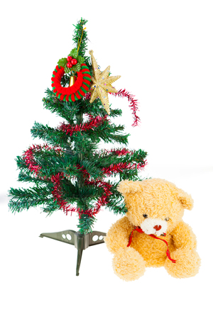 Joyful studio shot of a Christmas tree with colorful ornaments, isolated on white and bear dollの写真素材