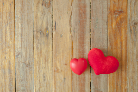 Red mini heart on wooden plate with copy spaceの写真素材