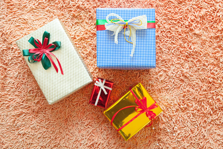 Christmas ornaments and gift box on carpet background. Merry Christmas and Happy New Year!! Top view.の写真素材