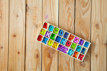 Colorful English letters in the wood boxes for decoration wording as a new year, Christmas on wooden background.の写真素材