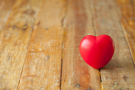 Red mini heart on wooden plate with copy spaceの写真素材
