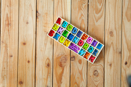 Colorful English letters in the wood boxes for decoration wording as a new year, Christmas on wooden background.の写真素材
