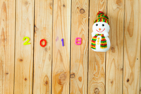 2018 colorful alphabet and snow man on wooden plank backgroundの写真素材