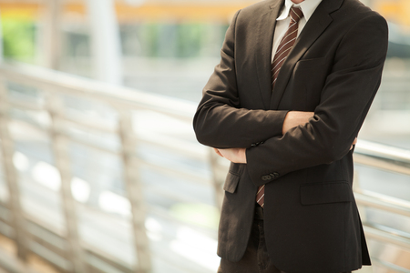 Confident businessman. Confident young man in full suit looking away while standing outdoorsの写真素材