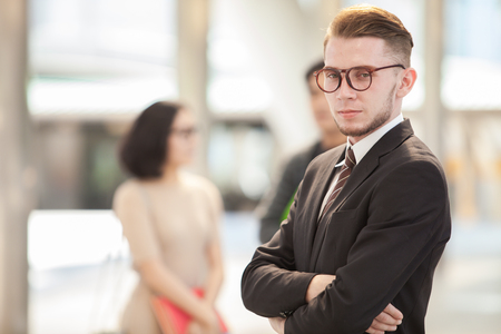 Confident businessman. Confident young man in full suit looking away while standing outdoorsの写真素材