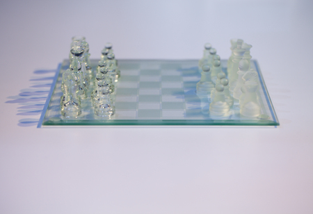 Glass chess on the transparent chessboardの写真素材