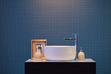 Interior of bathroom with washbasin faucet and picture frame and small bottles .Modern design of bathroomの写真素材