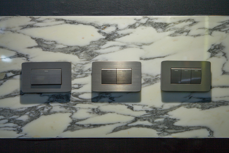 Modern light electrical switch with modern marble background.の写真素材