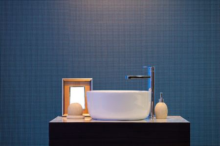 Interior of bathroom with washbasin faucet and picture frame and small bottles .Modern design of bathroomの写真素材