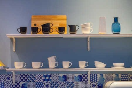 coffee mug shelf, black and white coffee mug glass on shelfの写真素材